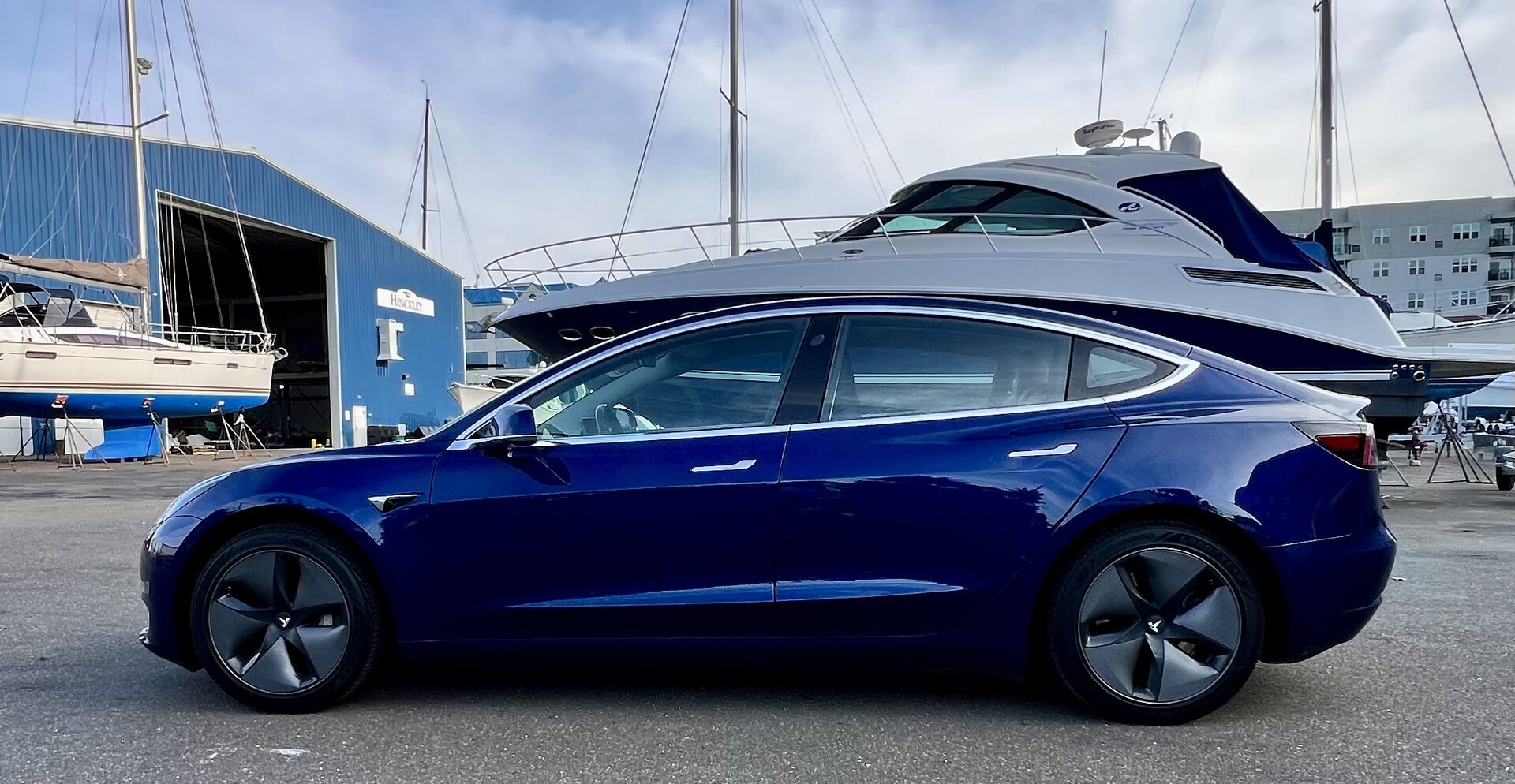 Tesla Model 3 in the Hamptons — yacht harbor backdrop